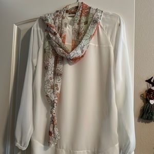 Floral scarf - orange, light green, and cream daisies. 13” x 64”.